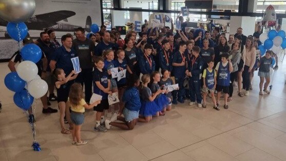 The cheer squad ready at the city's airport to welcome the Rockhampton Rockets home after the silver-medal winning performance at the Australian Under-14 Club Championships. Photo: Kent Murray