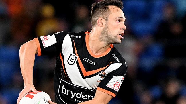 GOLD COAST, AUSTRALIA - JUNE 08: Luke Brooks of the Tigers looks to pass during the round 15 NRL match between Gold Coast Titans and Wests Tigers at Cbus Super Stadium on June 08, 2023 in Gold Coast, Australia. (Photo by Bradley Kanaris/Getty Images)