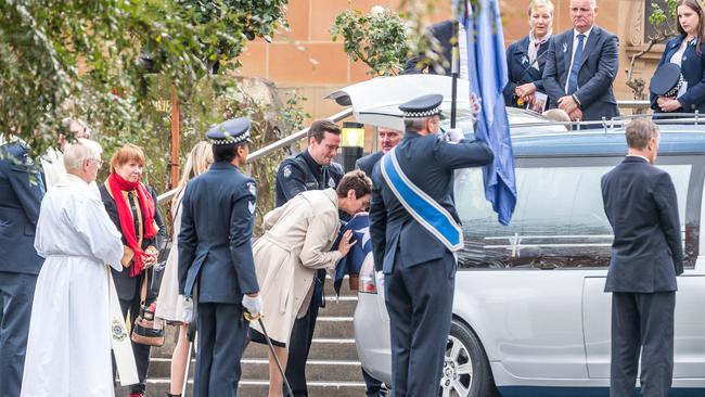 Constable Prestney’s mother kisses the coffin. Picture: Jake Nowakowski