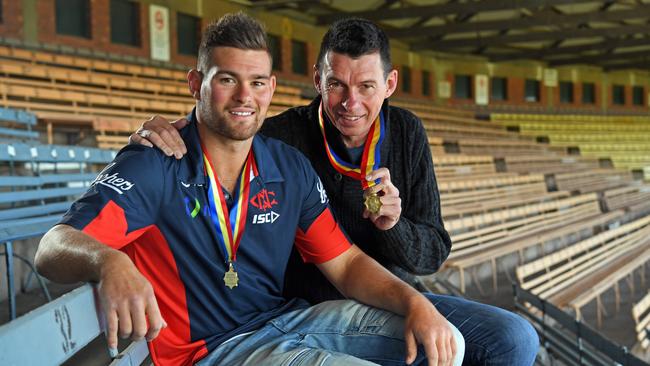 Mitch Grigg and his dad Chris, who has MND, with Mitch’s two Magarey Medals at Norwood Oval. Picture: Tom Huntley