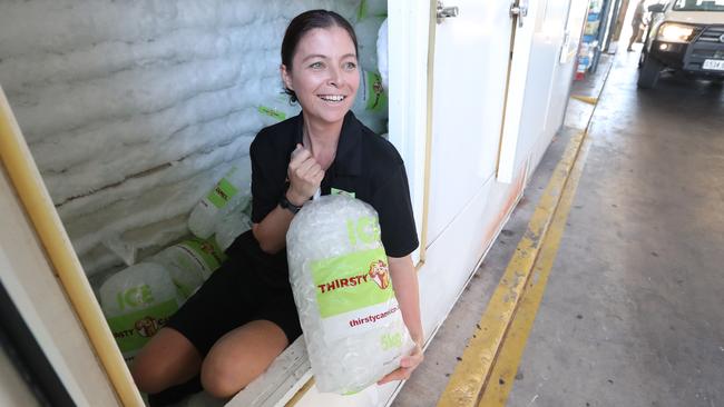 Bottle shop worker Brigette Taheny, 36, cooling off in the freezer at Roxby Downs. Picture: Tait Schmaal.