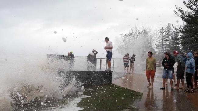 Spectators at Burleigh get covered by water. Picture: Adam Head