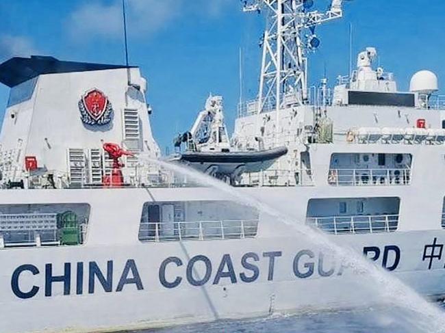 This undated handout released by the Philippine Coast Guard (PCG) on August 6, 2023 shows a China Coast Guard ship (L) releasing water cannon on a Philippine Coast Guard ship near Second Thomas Shoal during a re-supply mission on August 5. The Philippines condemned the China Coast Guard on August 6 for allegedly firing water cannon at its vessels in the disputed South China Sea, describing the actions as "illegal" and "dangerous". (Photo by Handout / Philippine Coast Guard (PCG) / AFP) / -----EDITORS NOTE --- RESTRICTED TO EDITORIAL USE - MANDATORY CREDIT "AFP PHOTO / PHILIPPINE COAST GUARD (PCG) " - NO MARKETING - NO ADVERTISING CAMPAIGNS - DISTRIBUTED AS A SERVICE TO CLIENTS