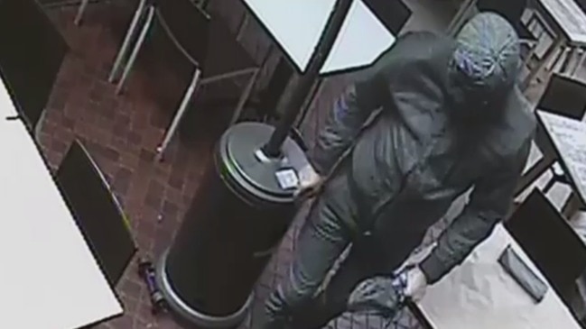 Police looking for masked man after restaurant owner stabbed, building set alight