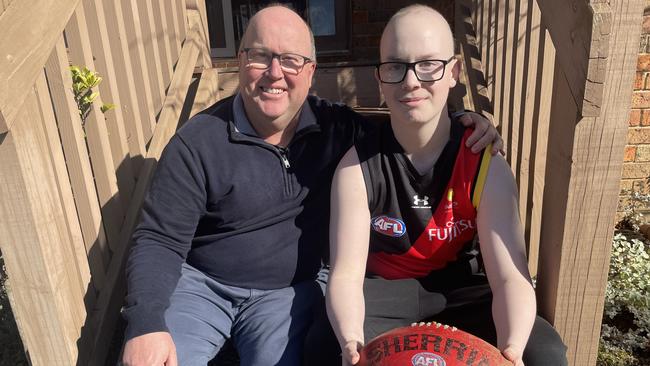 Ethan Westwood, 14, left, with dad Derek at their Templestowe home. Ethan is a huge Essendon fan and is battling a fresh cancer battle after going through 10 months of treatment. Picture: Kiel Egging.