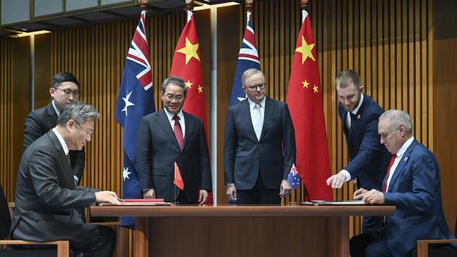 Chinese Commerce Minister Wang Wentao and Trade Minister Don Farrell during a signing ceremony at Parliament House in Canberra. Picture: NewsWire / Martin Ollman