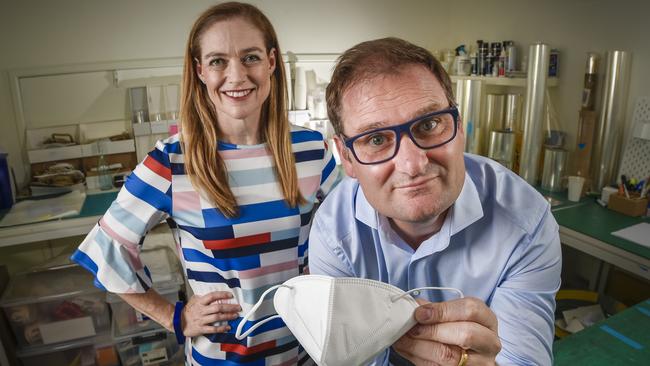 DETMOLD director Sascha Detmold Cox with CEO Alf Ianniello and one of the masks made in Adelaide. Picture: Roy VanDerVegt