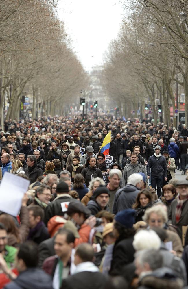 We are Charlie ... Crowds walk down a tree-lined boulevard in Paris. Picture: Martin Bureau/AFP