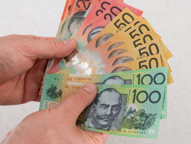 Man holding Australian money financial