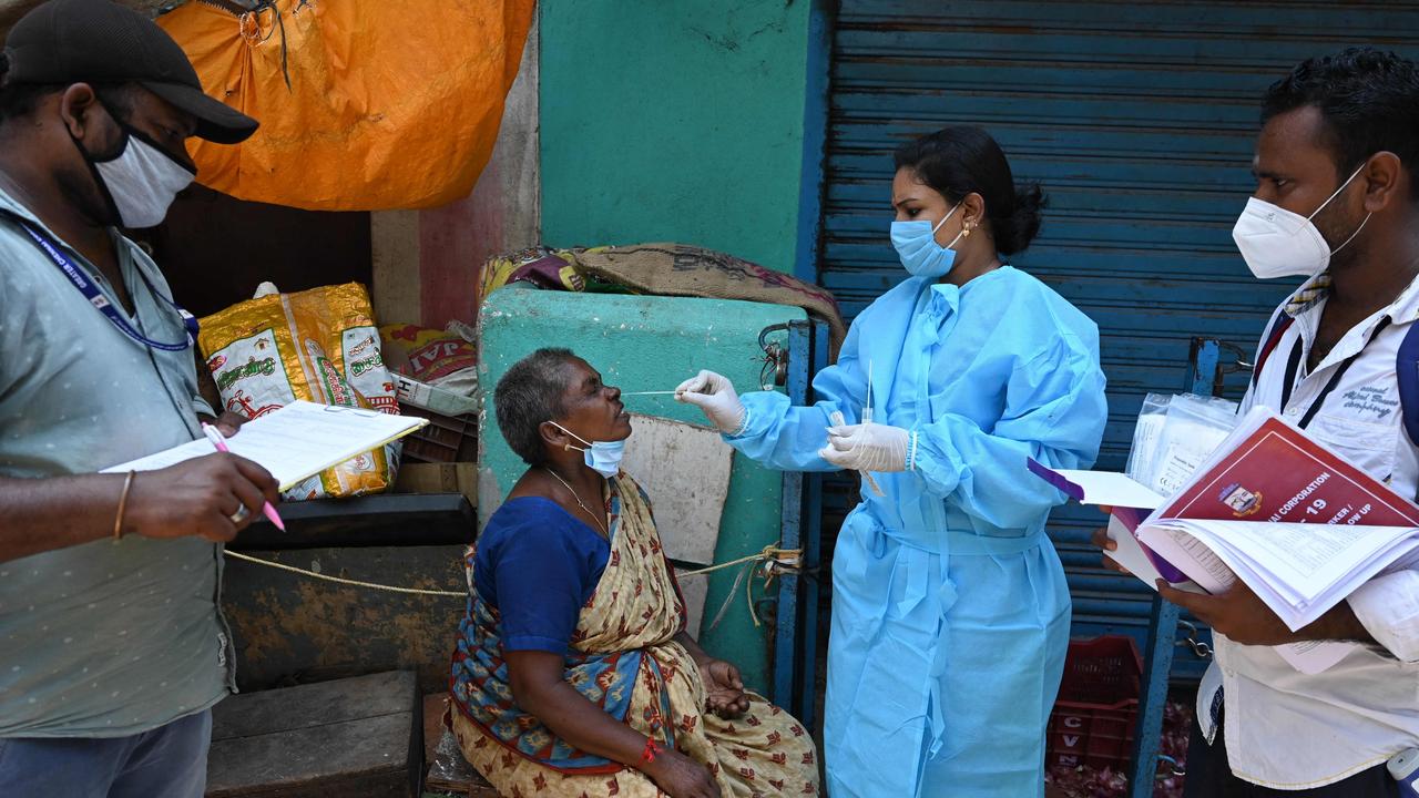 A health worker takes a swab sample from a woman at a market in Chennai in Covid-ravaged India. Picture: AFP