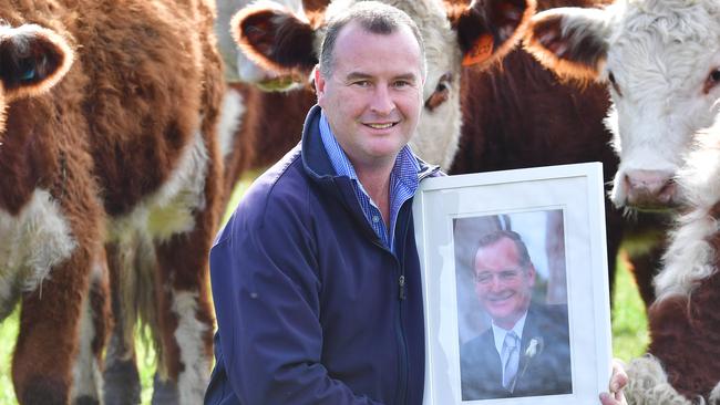 Alan Whelan on the family farm with a photo of his dad Max, who donated his organs after a farming accident. Picture: Zoe Phillips