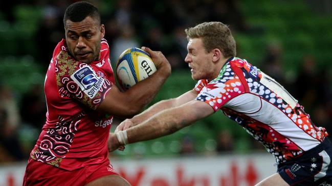 Super Rugby - Melbourne Rebels v Queensland Reds at AAMI Park, Reds Samu Kerevi breaks a Bryce Hegarty tackle. June 27th 2014. Picture : Colleen Petch