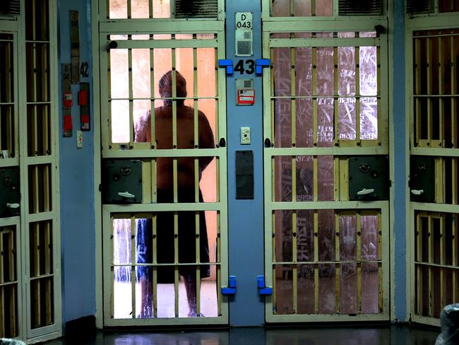 A prisoner peers through his cell door in Darcy 1 compound in D Block. Picture: Adam Taylor