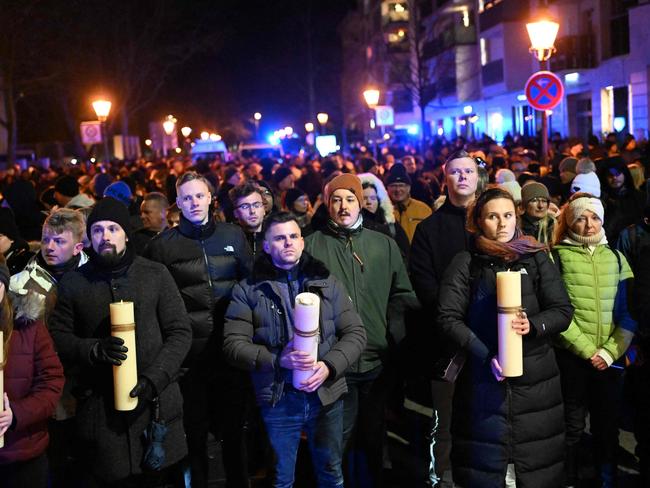 People attend a commemoration organised by the far-right Alternative for Germany (AfD) party at the cathedral square, after the Christmas market car-ramming attack in Magdeburg, eastern Germany, on December 23, 2024. Three days after the Magdeburg Christmas market car-ramming attack, both the far-right AfD party and counter-protesters were due to hit the streets in the bereaved city. Magdeburg has been in deep mourning over the mass carnage on Friday evening, December 20, 2024, when an SUV smashed through a crowd at its Christmas market, killing four women and a nine-year-old child and injuring 205 people. Political pressure has built on the question of potential missed warnings about Saudi suspect Taleb al-Abdulmohsen, a 50-year-old psychiatrist who had made online deaths threats and previously had trouble with the law. (Photo by RALF HIRSCHBERGER / AFP)