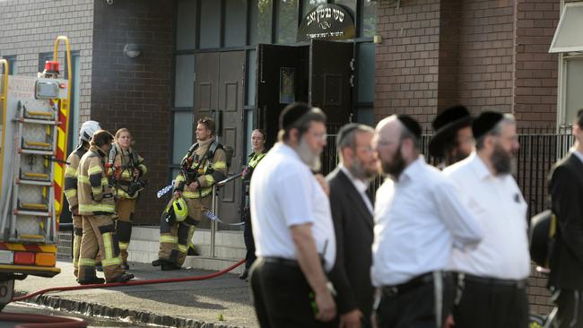 People gather outside a synagogue at East St Kilda after an overnight fire. Picture: Andrew Henshaw