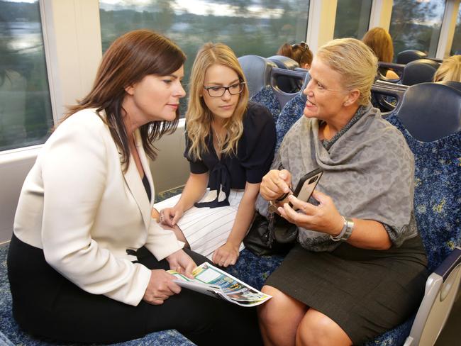 Lucy Wicks speaking with commuters Natasha Bertam of Green Point and Kylie Edwards of Woy Woy. Picture: Mark Scott