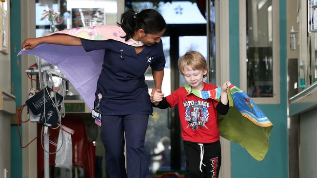 Super Cohen shows nurse Lisieux Joseph how to run with your cape flying in the breeze.