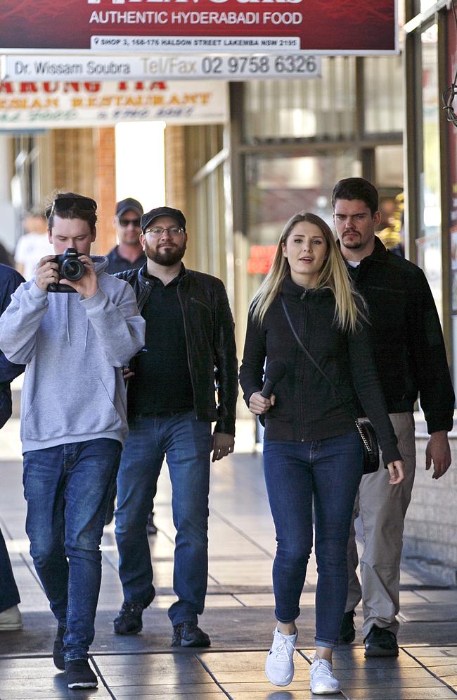 YouTuber Lauren Southern walks Lakemba streets with her security and media team. Picture: Tim Pascoe