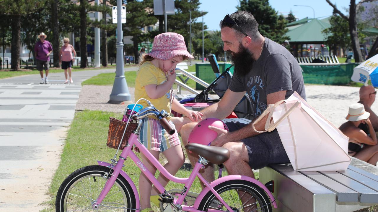 Zane halligan from labrador consoles daughter Zarli 4 after a bicycle incident.. Picture Glenn Hampson