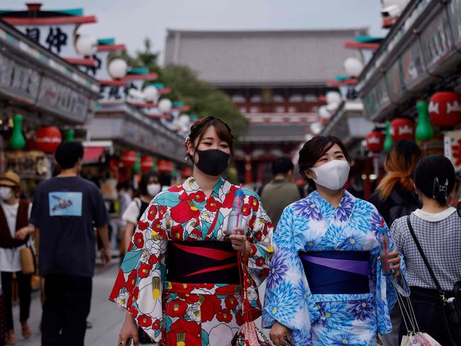 TOPSHOT – Women wearing yukatas, a traditional Japanese summer outfit, visit the Sensoji Buddhist temple on August 12, 2021 in Tokyo's Asakusa district. (Photo by David GANNON / AFP)