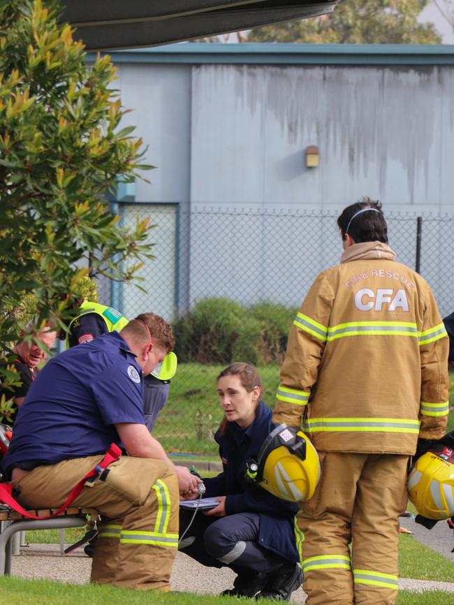 A paramedic talks to a firefighter after the blaze. Picture: Joel Stewart