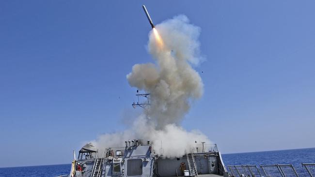 The Arleigh Burke-class guided-missile destroyer USS Barry (DDG 52) launching a Tomahawk cruise missile to support Joint Task Force Odyssey Dawn in the Mediterranean Sea.