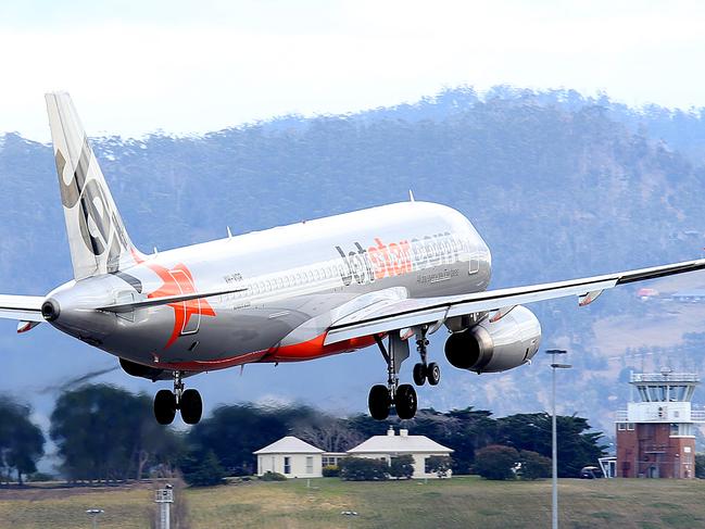 SUNTAS: Generic shots of planes taking off or coming into land, at Hobart Airport. a Jetstar plane landing