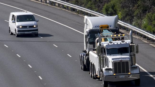 The truck involved in the crash is towed from the Eastern Freeway crash site late on Thursday morning. Picture: Getty Images