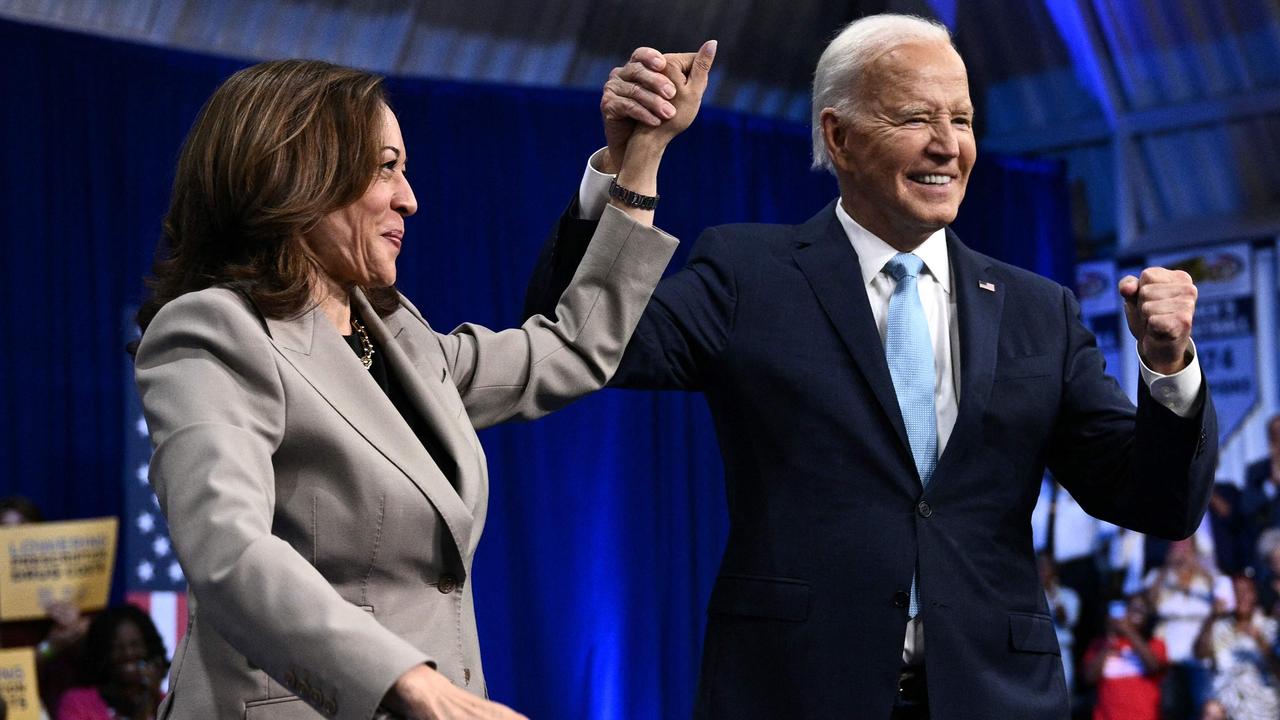 Mr Biden and Ms Harris clasp and raise their hands at the event. Picture: Brendan SMIALOWSKI/AFP