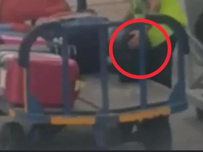 A passenger on a flight to Madrid filmed a baggage handler taking an item from a passenger's suitcase.