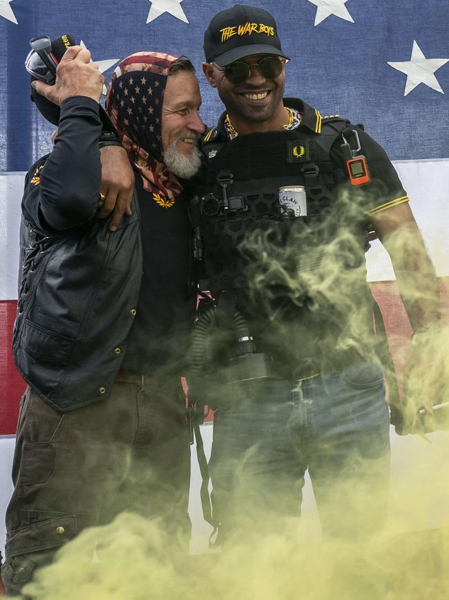 Proud Boy leader Enrique Tarrio (R) hugs a fellow member during a Proud Boy rally in Oregon. Picture: AFP.