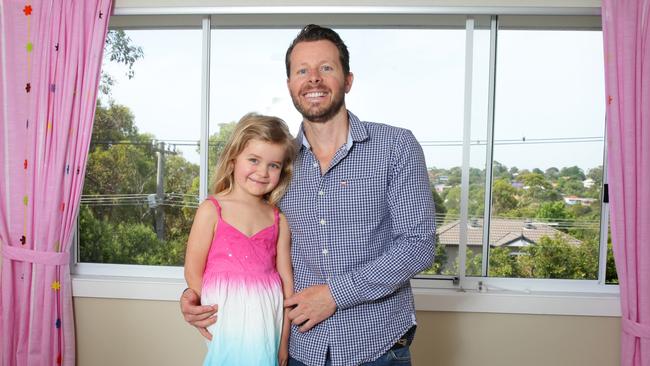 Mike Collins and daughter Remmie in front of a window fitted with Remsafe / Picture: Cameron Richardson