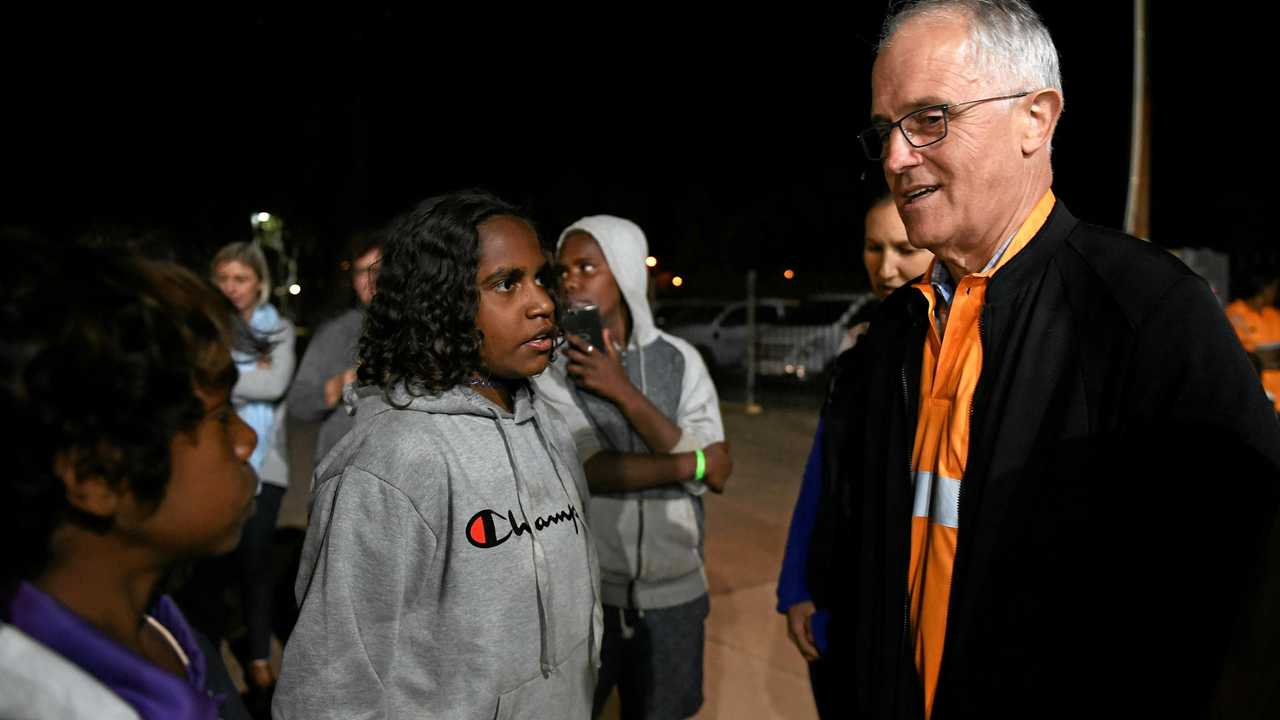 SEEKING ANSWERS: Prime Minister Malcolm Turnbull meets local kids as he rides along in a Julalikari Youth Night Patrol convoy at Tennant Creek . Picture: DAN HIMBRECHTS