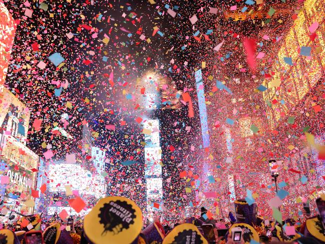 Onlookers watch as confetti fills the air to mark the beginning of the new year, in Times Square, New York. Picture Yuki Iwamura / AFP