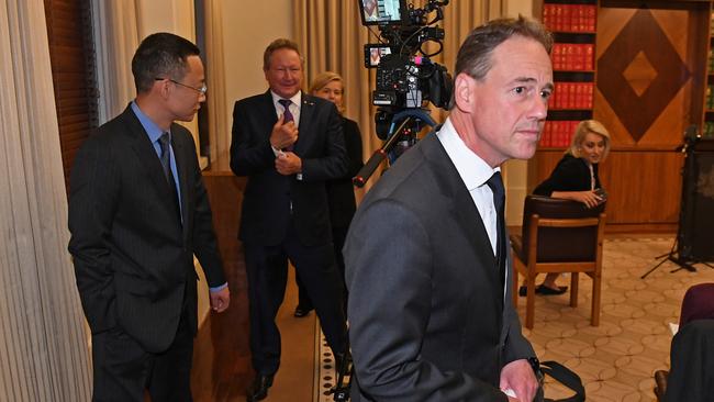 Health minister Greg Hunt, right, departs a press conference that featured appearances by consul-general for Victoria Long Zhou, left, and Andrew Forrest. Picture: AAP