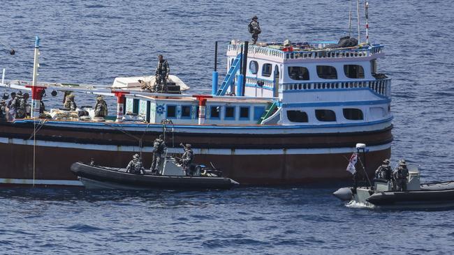 HMAS Darwin intercepts an arms smuggler approximately 170 nautical miles off the coast of Oman. A search of the vessel revealed a significant amount of military weapons hidden inside the cargo hold. Picture: Department of Defence