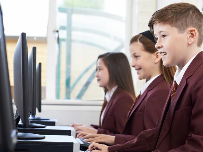 Pupils Wearing School Uniform In Computer Class