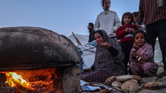 A displaced Palestinian bakes bread to break the fast on the first day of Ramadan, in Rafah. Picture: AFP