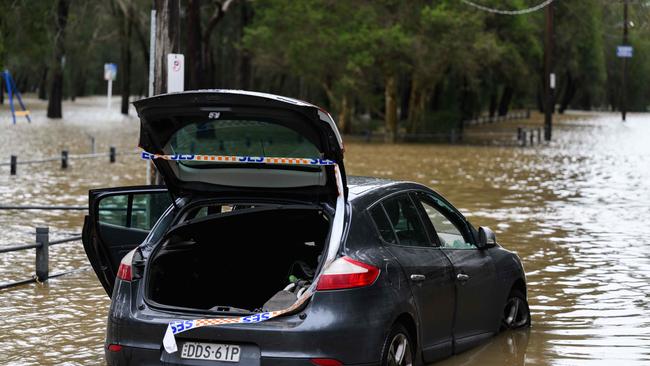 An abandoned flooded car in the Deepwater Park near Georges River, Sydney. Picture: NCA NewsWire / James Gourley