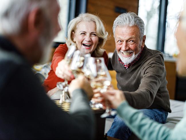 SENIOR/PENSIONER/MATURE/ELDERLY/OVER 65/GRANDPARENT/RETIREE/SUPERANNUATION. Picture: istock Happy mature couple toasting with their friends during social gathering at home.