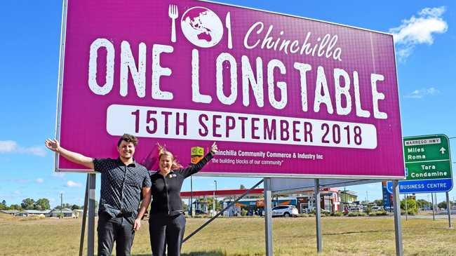 SIGN OF WHAT'S TO COME: CCCI staff Justin Fox and Gaye Smith celebrate the launch of their billboard for the One Long Table event. Picture: Madison Watt