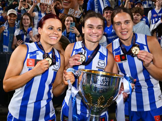 MELBOURNE, AUSTRALIA - NOVEMBER 30: Jenna Bruton, Ash Riddell and Jasmine Garner of the Kangaroos celebrate during the AFLW Grand Final match between North Melbourne Tasmanian Kangaroos and Brisbane Lions at Ikon Park, on November 30, 2024, in Melbourne, Australia. (Photo by Quinn Rooney/Getty Images)