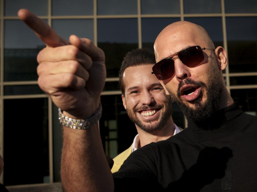 Andrew Tate gestures, next to his brother Tristan, outside the Bucharest Tribunal in Bucharest, Romania in January. Picture: AP Photo