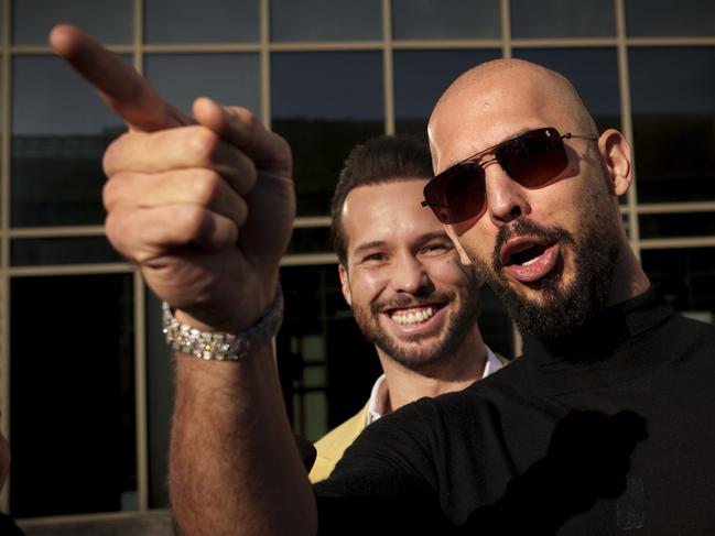 Andrew Tate gestures, next to his brother Tristan, outside the Bucharest Tribunal in Bucharest, Romania in January. Picture: AP Photo