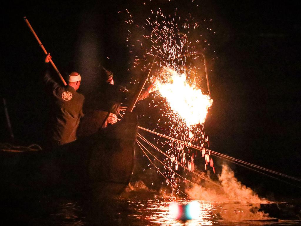 The shimmering torchlight adds enchantment to the ancient ritual, casting ethereal reflections on the Nagara’s waters. Picture: Nicholas Eagar