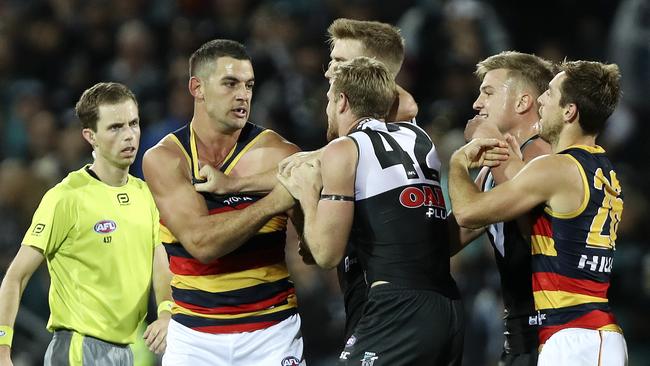 Taylor Walker and Tom Jonas exchange pleasantries at three-quarter time. Picture Sarah Reed