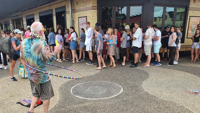 A busker provided entertainment for those waiting in the long queue for Splendour in the Grass locals' tickets at the Great Northern Hotel in Byron Bay on Sunday.