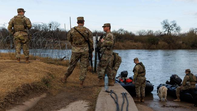 Texas National Guard soldiers wait at the boat ramp where law enforcement enters the Rio Grande at Shelby Park last Friday. Picture: Getty Images