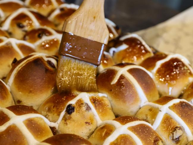 Glazing hot cross buns. Picture: Jenifer Jagielski