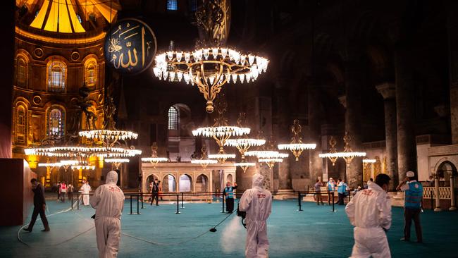 Fatih Municipality workers disinfect the interior of Hagia Sophia mosque after the night prayer in Istanbul. Picture: AFP